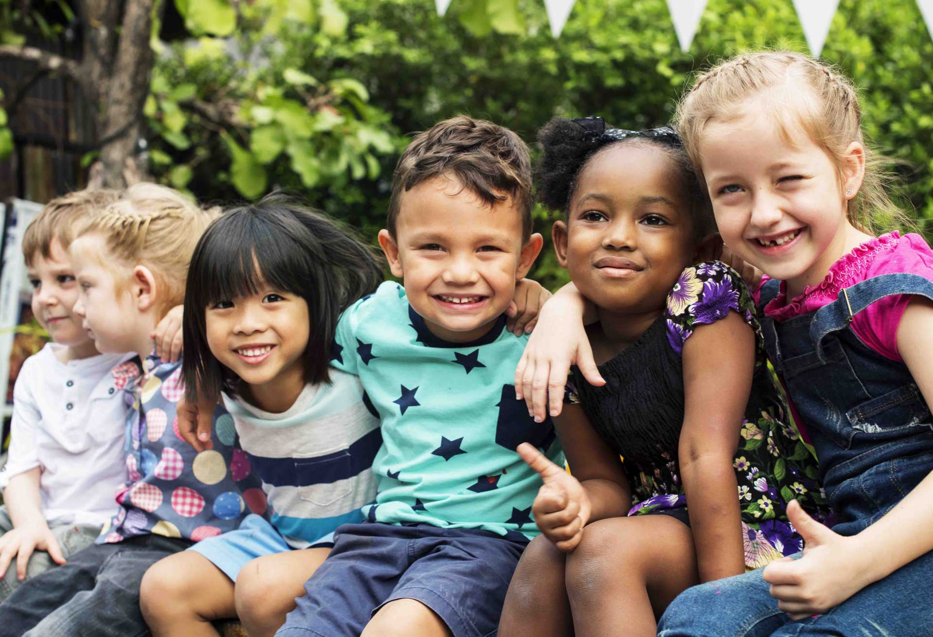 Children smiling together outdoors